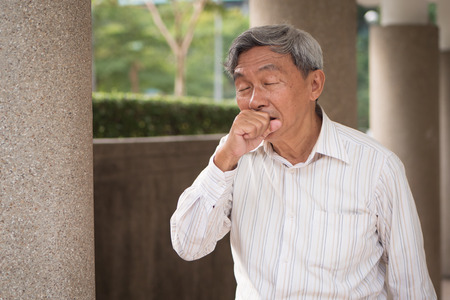 sick senior man coughingの写真素材
