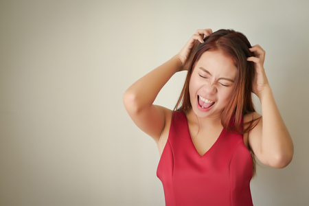 stressed headache upset angry woman screaming, shouting out loudの写真素材