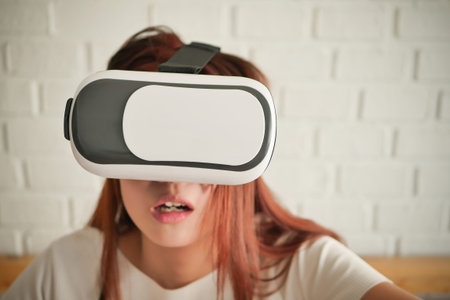 stunned fearful woman playing horror or suspense VR headset