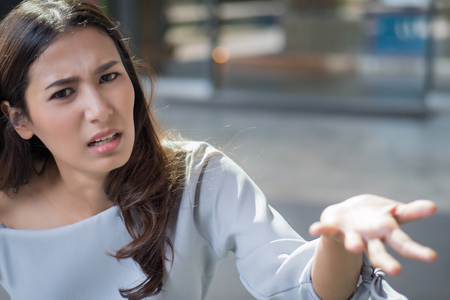 unhappy upset woman shruggingの写真素材