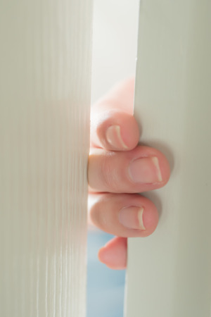 woman hand or finger pinched by the door; close up portrait of finger pinched, slammed by the door, home accident concept; 30s asian adult woman hand or finger modelの写真素材
