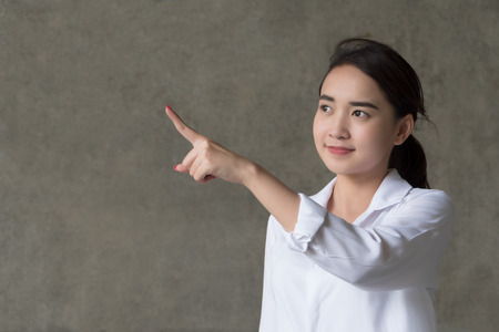 Confident happy Asian woman in white shirtの写真素材