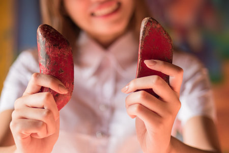 happy smiling woman holding yin yang fortune telling wood with positive, lucky outcome; concept of...