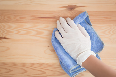 woman cleaner cleaning living room in apartment. portrait of asian woman cleaning staff doing housekeeping or domestic helper job. young adult asian woman modelの写真素材