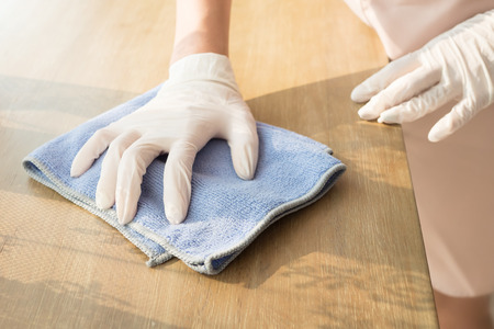 woman cleaner cleaning living room in apartment. portrait of asian woman cleaning staff doing housekeeping or domestic helper job. young adult asian woman modelの写真素材