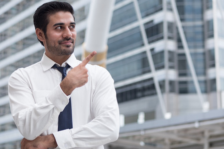 asian business man pointing up; portrait of Asian, north indian successful and confident businessman points his finger upの写真素材