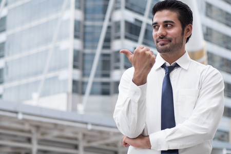 asian business man pointing thumb up gesture; portrait of Asian, north indian successful and confident businessman points his approving, yes, ok thumb upの写真素材