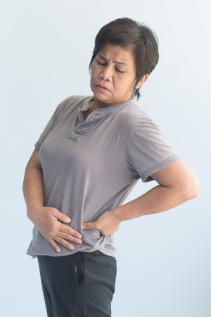sick old senior woman suffering from pelvic pain, hip stiffness, gout, rheumatoid, osteoporosisの写真素材