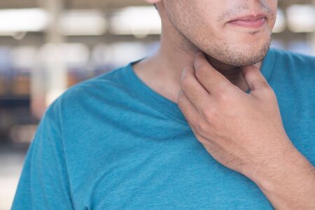 sick man getting a cold or flu with sore throat, congested throat with phlegm