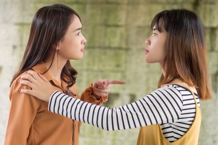 two women having conflict, arguing each otherの写真素材
