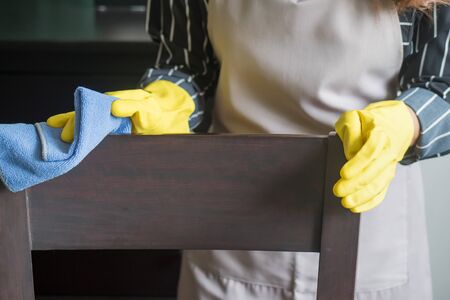 portrait of asian woman cleaning service staff cleaning dining table in dining roomの写真素材