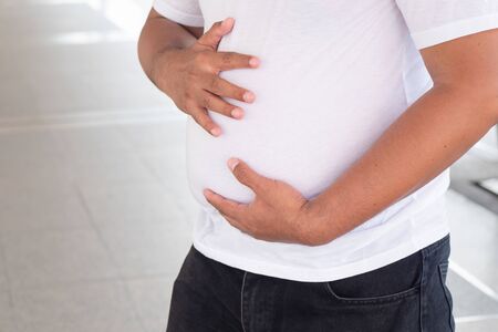 belly of old fat man; concept of eating disorder, soft and round dad body or dad bodの写真素材