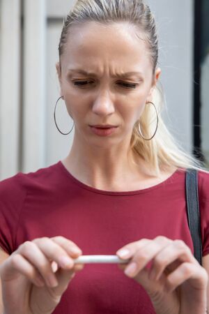 determined woman trying to quit smoking and breaking her cigarette, concept of no smoking, stop smoking, health care, healthy lifestyle without tobacco and cigaretteの写真素材