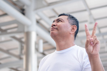 old man pointing up v for victory 2 fingers; senior old man model for senior citizen, pensioner,...
