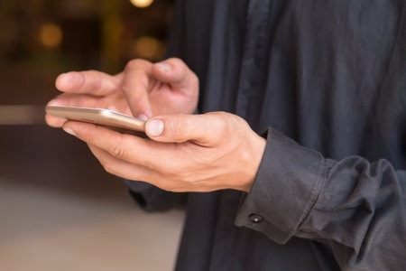 caucasian business man hand using smartphone; hand of businessman working with this smartphone,...
