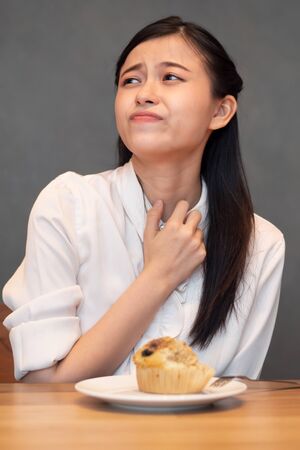 woman with no food appetite, anorexia symptoms, food poisoning, choking hazard, health care conceptの写真素材