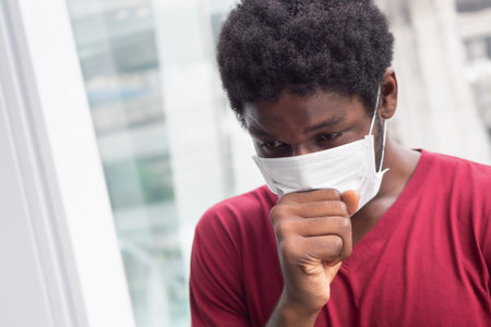allergic sick black African man coughing with sore throat; concept of african man with allergy,...