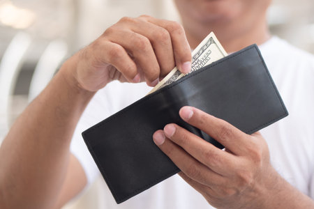 old senior man having some money in his wallet; concept of money revenue, wages, economic growth,...