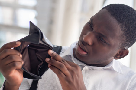 Jobless African black man have no money; concept of no money, economic recession, great depression,...