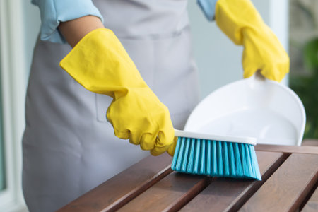 asian woman cleaning home, doing housework with duster