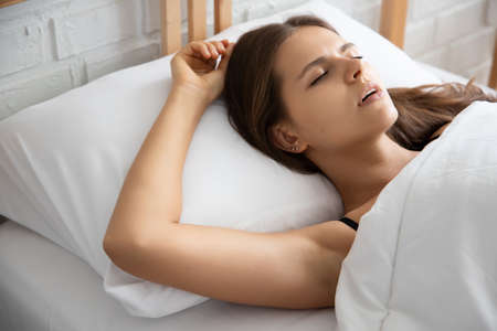 tired woman sleeping and snoringの写真素材