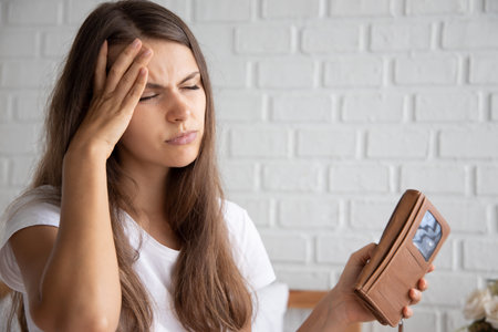 frustrated, shocked, stressed women with expensive bill, debt invoice, eviction notice; concept of...