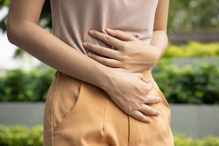 Asian woman scratching her arm skin; concept of dry skin, allergic skin inflammation, body care, fungus inflammation, dermatology disease, eczema, rash, skin care; young adult asian woman modelの写真素材