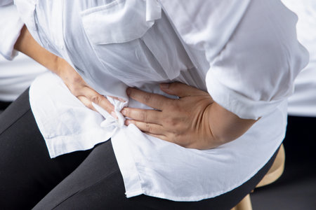 sick asian middle aged woman getting a cold or flu with sore throat, coronavirus infection or...