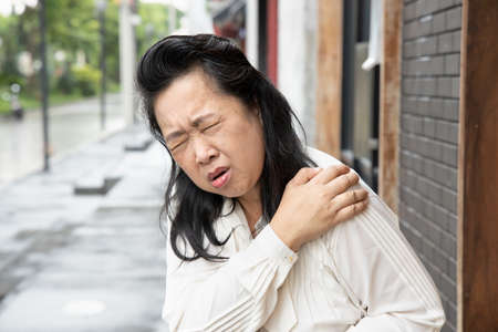 Old asian woman having knee joint pain or knee injury problemの写真素材