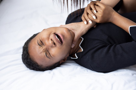 African woman being abused, concept of domestic violence, crime of physical assault or attempted murder in family memberの写真素材