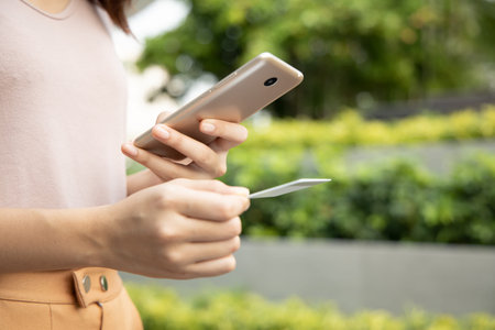 happy smiling asian woman using smartphone and credit card for online shopping, concept of...