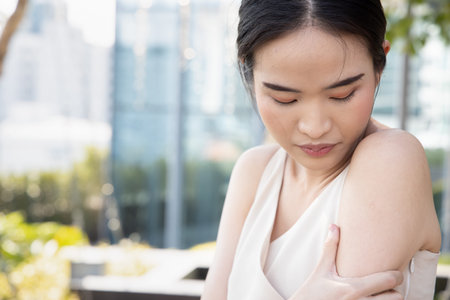 Asian woman getting vaccinated immunity with keloid scar on her upper arm, concept of universal...