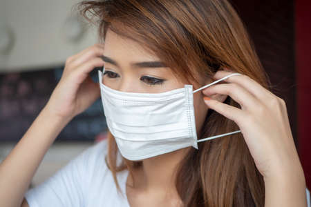 woman wearing face mask from having coronavirus infectionの写真素材