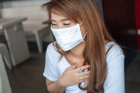 sick woman with face mask for preventing the spread of diseaseの写真素材