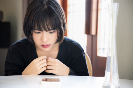 Angry upset asian woman with smartphone, problem concept of online shopping, distant togetherness,...