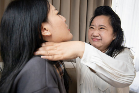 Lovely asian senior mother and young daughter talking, chatting, consulting together with happy family life, single mom, togetherness conceptの写真素材