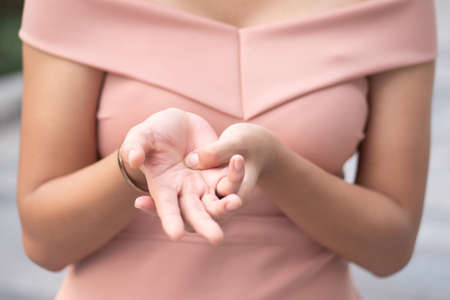 sick woman with trigger finger pain, portrait of sick asian woman suffering from trigger finger, CTS, wrist joint pain, arthritis, gout, gouty pain health care conceptの写真素材