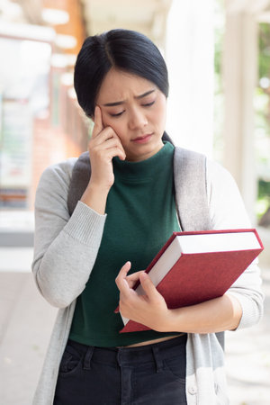 Excited asian woman college student giving thumb up while getting back to school after vaccination rollout program, header banner design with blank spaceの写真素材