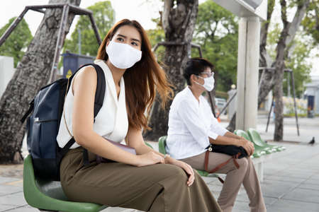 vaccinated people still wearing mask in outdoor public space as covid coronavirus variant spreadの写真素材