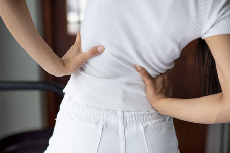 woman suffer from lower back pain, herniated spinal disc, spine displacementの写真素材
