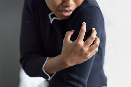 Hand of young black African woman scratching her hand skin, concept of easy allergic skin, dry...