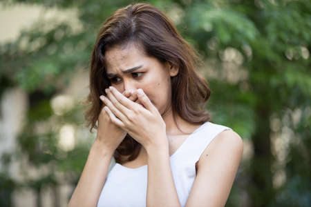 asian woman having bad breath problemの写真素材