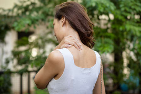 Back of asian woman having shoulder pain, office syndromeの写真素材