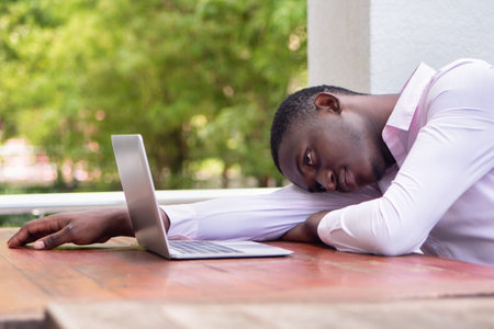 Exhausted and hopeless black African business man, concept of slow internet connection, internet...
