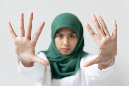 Happy smiling muslim woman showing black smartphone screen