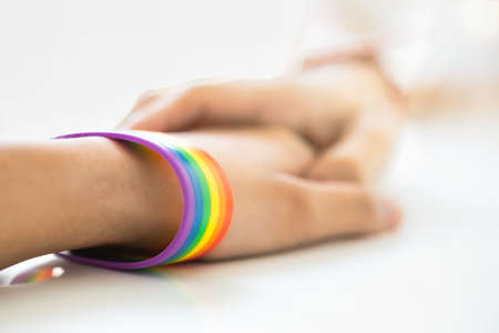 closeup of LGBT peoples' helping hand holding each other, concept of LGBT pride month and LGBT awareness dayの写真素材