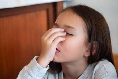 Tired and sleepy young little girlの写真素材