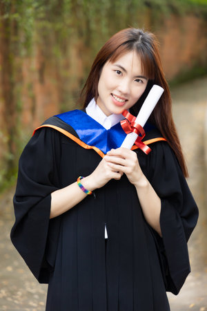 Newly college graduated LGBT person holding honored degrees, concept of equal education opportunity for all non-binary LGBT peopleの写真素材