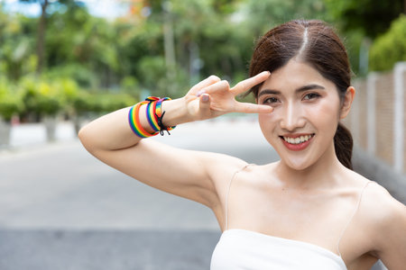 Non-binary LGBT person showing winning V for Victory hand sign for LGBT awareness pride monthの写真素材