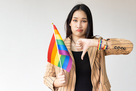 Non-binary LGBT person showing bad rejecting thumb down hand sign, concept image for LGBT awareness pride monthの写真素材